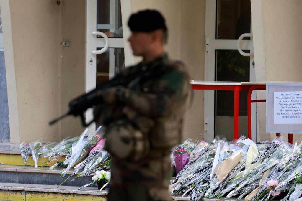 Flowers are laid outside a school where a teacher was killed by a former pupil on Friday, October 13 | Photo: Reuters