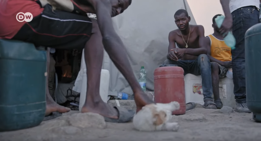 The men seem broken and tired after hours laboring in the fields. They are ashamed of the conditions in which they live | Photo: Screenshot DW documentary Tomatoes and Greed