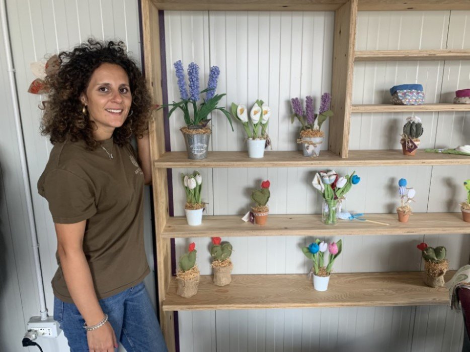 Letizia Blandino is the head of Social Tailoring at Proxima and stands here next to some of the products the project sells, made by beneficiaries like Blessing | Photo: Emma Wallis / InfoMigrants