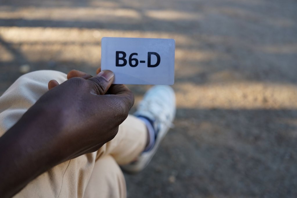 A man shows the plastic registration card he was given at the Eisenhüttenstadt Dublin center. The 'D' indicates that he is a Dublin case | Photo: Sofia Christensen