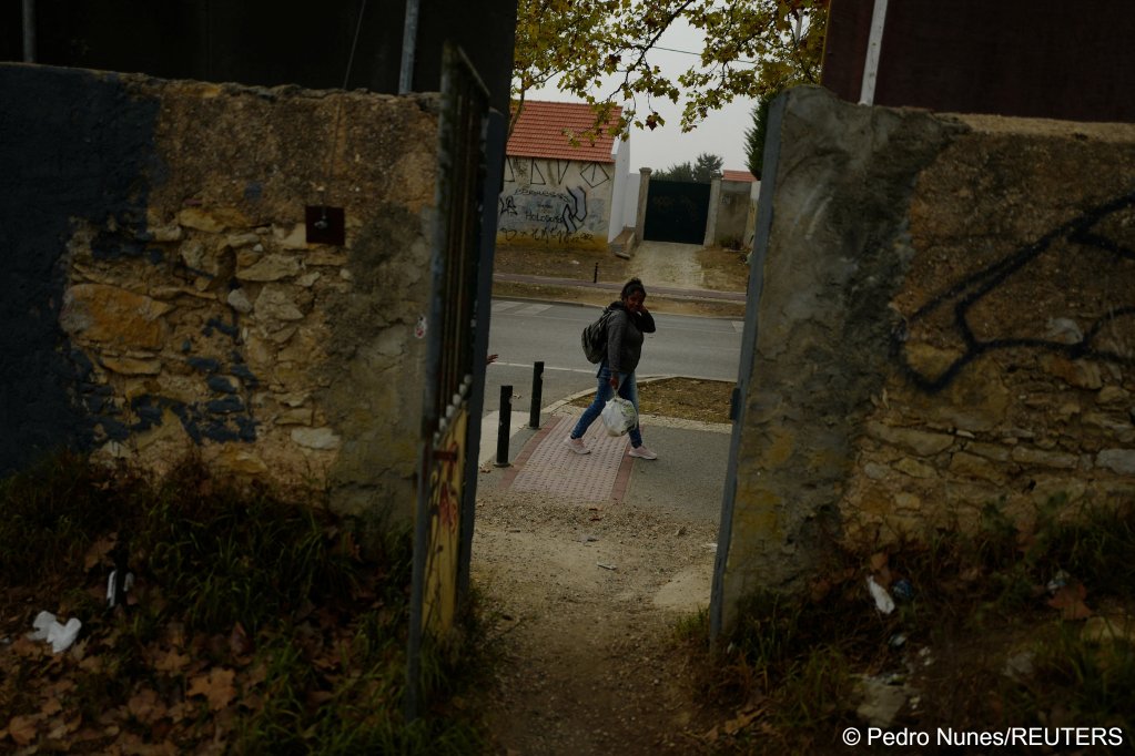 Andreia Costa, 50, from Sao Paulo, Brazil, leaves the improvised campsite in a field where she lives to catch the train and go to work as a cleaner, in Carcavelos, in Cascais, Portugal, October 11, 2023. Costa moved to Portugal from Brazil in 2022 | Photo:  Pedro Nunes / Reuters