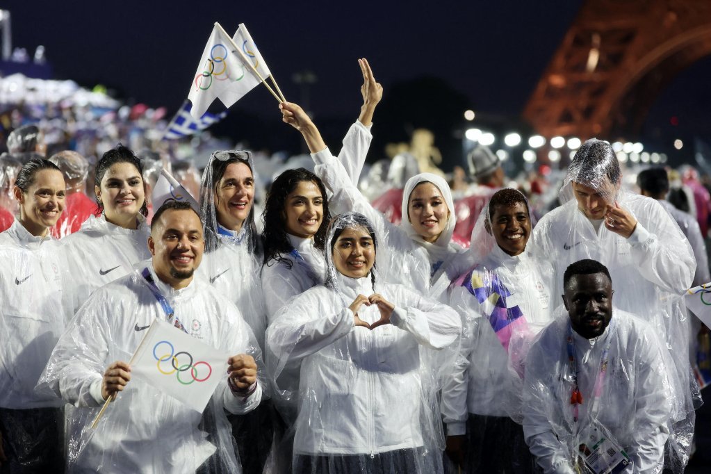 Members of the Refugee Olympic Team celebrate at the close of the 2024 Paris Olympics opening ceremony by the Eiffel Tower  | AFP/POOL - Photo: Cameron Spencer/AFP/Pool