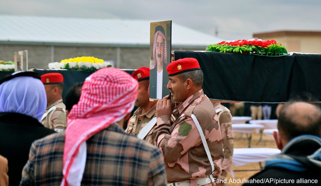 Mourners prepare to bury the remains of 104 Yazidi victims in a cemetery in the village of Kocho in Iraq's northern Sinjar region on February 6, 2021. The Yazidis were killed by the IS terror militia in 2015. The bodies were exhumed from mass graves in 2020 with the coordination of the United Nations Investigative Team to Promote Accountability for Crimes Committed by IS | Photo: Farid Abdulwahed/AP