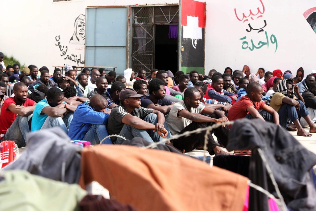From file: Detained migrants sitting in the Abu Salim detention center in Gasr Garabulli, 60 kilometers east of Tripoli, Libya | Photo: EPA/STR