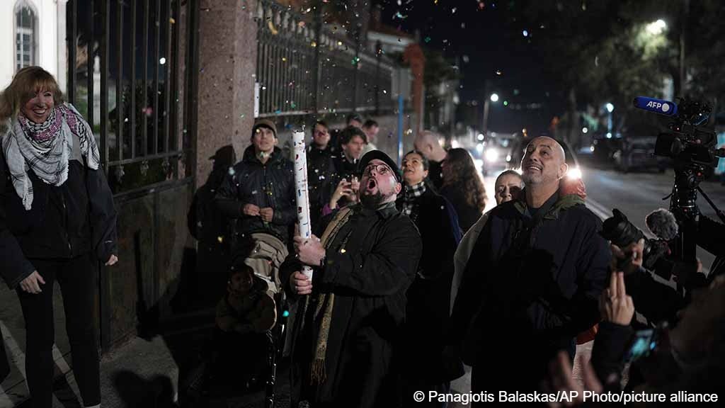 Rescue volunteers and their lawyer pose outside a courthouse in Mytilene, on the northeastern Aegean island of Lesbos, Greece, Thursday, Jan. 15, 2026, after being acquitted of charges related to aiding migrants. (AP Photo/Panagiotis Balaskas)
