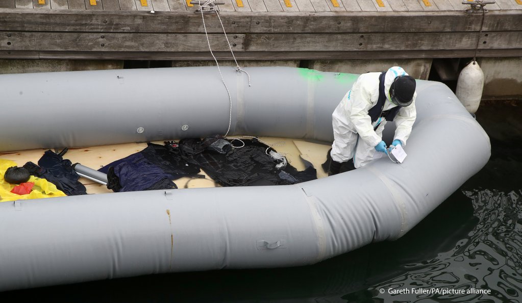 A Border Force officer labels a boat thought to have been used in a migrant crossing as a group of people thought to be migrants are brought into Dover, Kent, following a small boat incident in the Channel, April 20, 2021 | Photo: Gareth Fuller/picture alliance