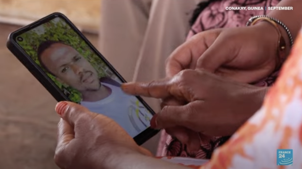 Family members show pictures of their son Idrissa who left Guinea in search of a better future | Screenshot: RFI
