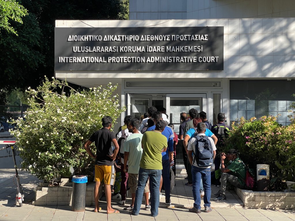 From file: A picture of the International Protection Administrative Court in Cyprus with a group of Bangladeshis waiting outside. Compared to its population size, Cyprus has one of the highest asylum seeking rates in the EU | Photo. Arafatul Islam / InfoMigrants