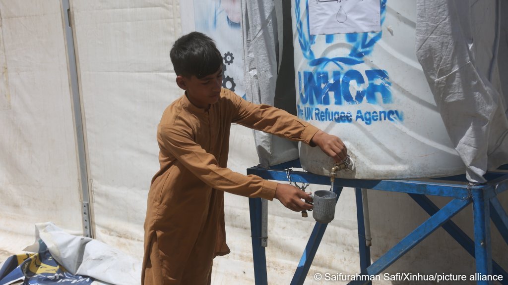 A boy fetches water in Kabul, Afghanistan, on June 11, 2026, at a makeshift camp for Afghans who returned to the country | Photo: picture alliance