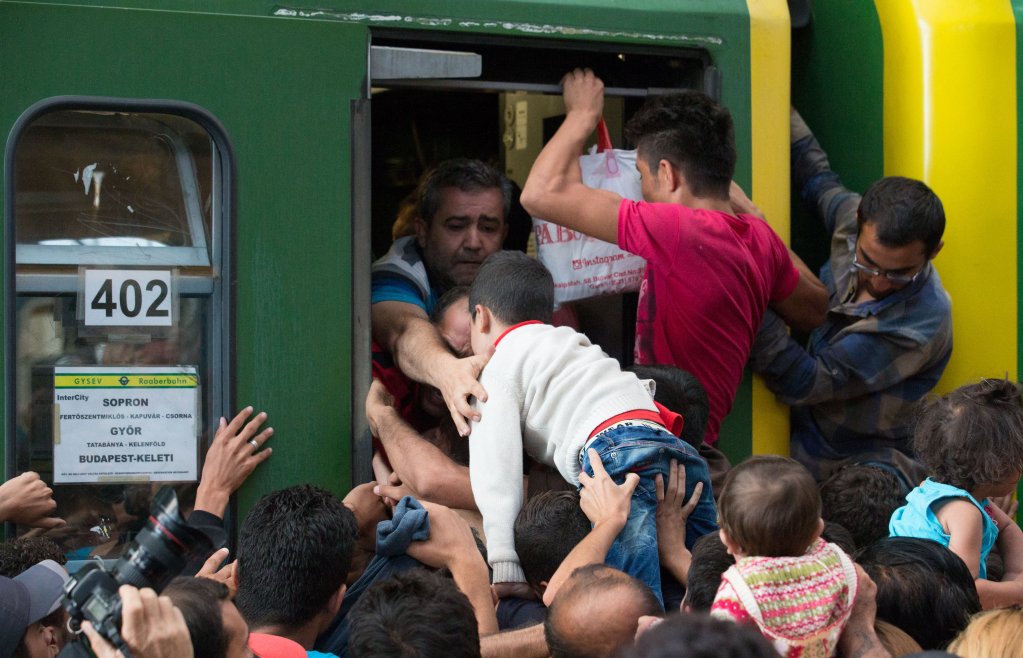 Migrants attempt to board a train bound for Austria on September 1, 2015, at Keleti Station in Budapest. Photo: AFP