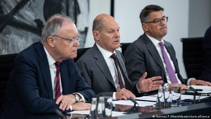 German Chancellor Olaf Scholz (middle) and Hesse state premier Boris Rhein (right) seen during a press conference on June 20, 2024