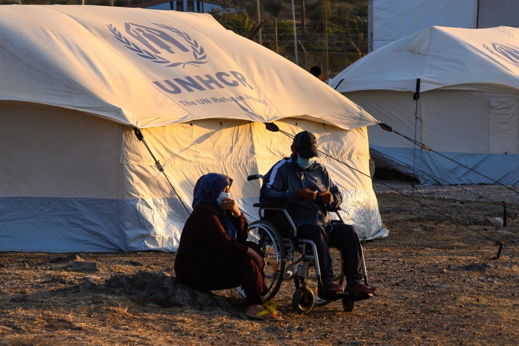 From file: A woman and a man in a wheelchair sit outside a tent at Kara Tepe camp on Lesbos island |  Photo: EPA/VANGELIS PAPANTONIS