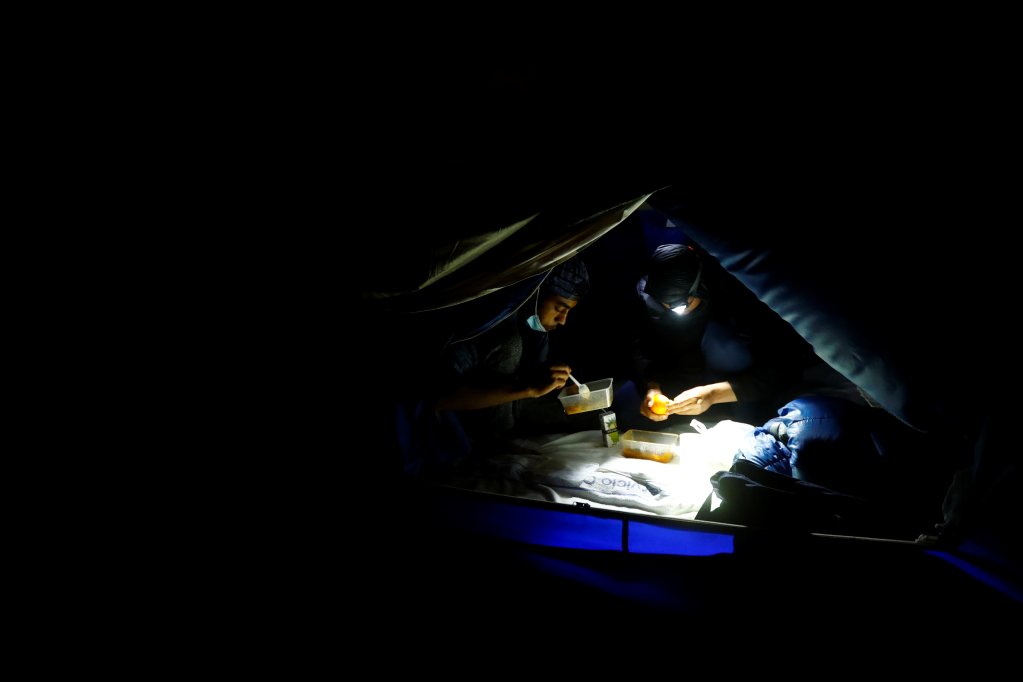 Migrants in a tent at night near Las Palmas | Photo: Reuters