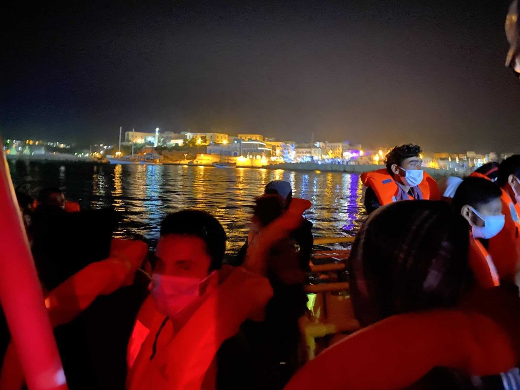 Some of the 85 rescued migrants on board the Aurora wait to disembark on Lampedusa | Source: @Seawatchcrew twitter feed
