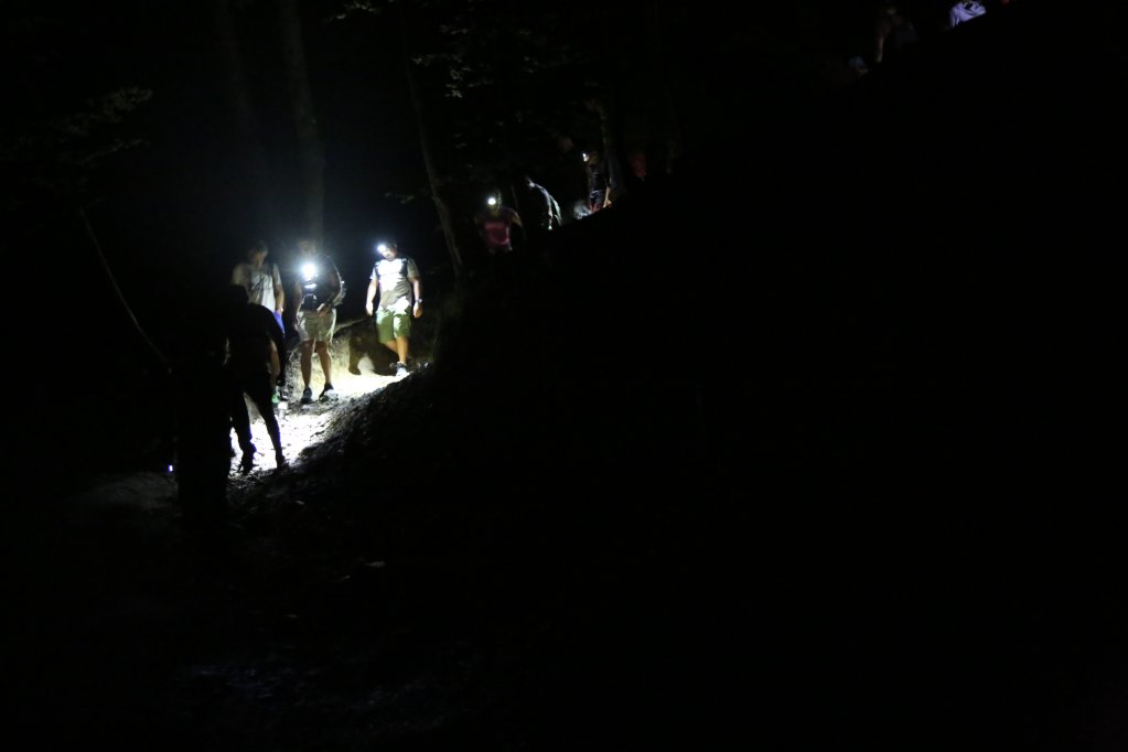 Participants of the night hike walk along the path together with headlamps guiding the way | Photo: Paul Huf