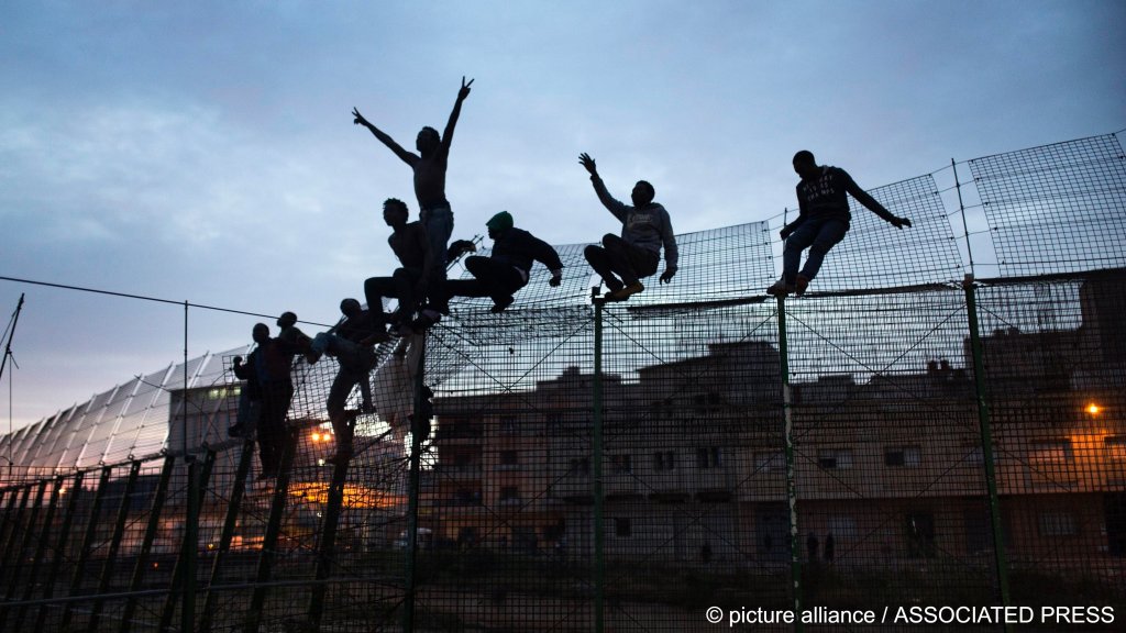 From the file: Sub-Saharan migrants climb over the metal fence separating Morocco from the Spanish enclave of Melilla on Friday, March 29, 2014.Photo: Santi Palacios/AP Photo/Photo Alliance