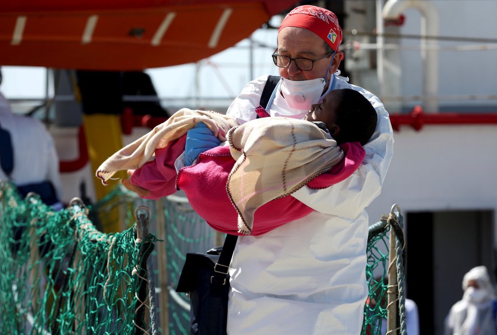 From file: A member of medical charity MSF holds a child rescued at sea as they disembark in Pozzallo, Sicily, in April 2016 | Photo: Reuters/Antonio Parrinello