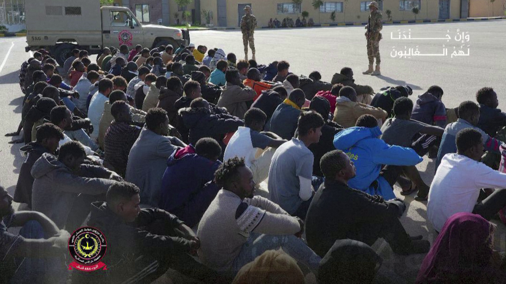 People in the Libyan desert the Libyan military says are detained migrants | Source: still from Reuters video