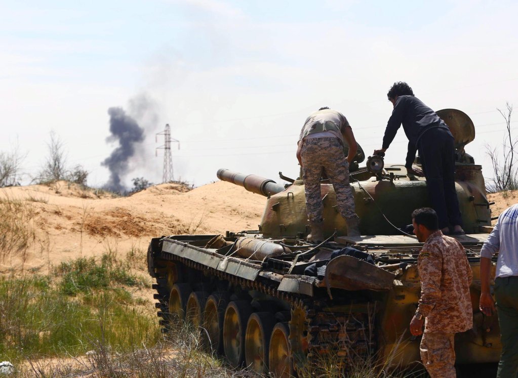 From file: A Libyan militia in command of a tank clashing with rivals near Bir al-Ghanam, 90 kilometers north of Tripoli, Libya. The situation is so complex in Libya, it is difficult to tease out all the factors pushing migrants, thinks Di Giacomo | Photo: EPA/Stringer