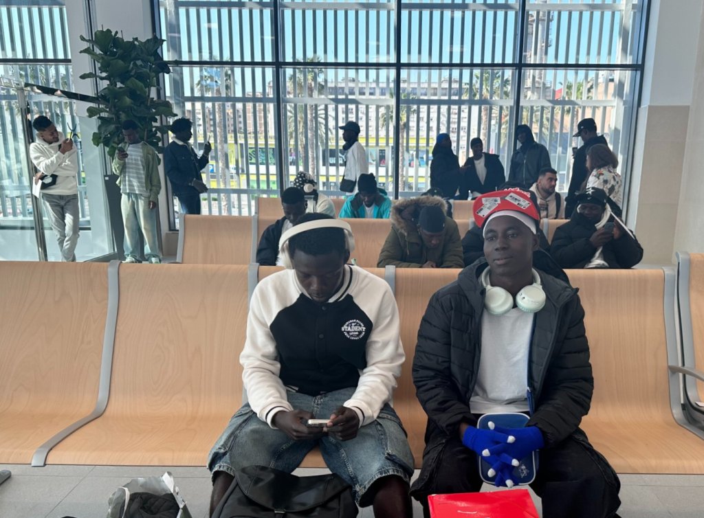 Kabirou Adamou Daouda (foreground, right) and other migrants wait to board the ferry to reach the Spanish peninsula, March 13th, 2026 | Photo: InfoMigrants