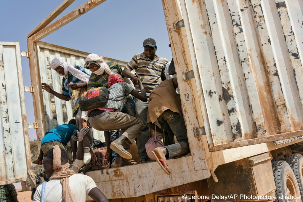 From file: Migrants climb into a truck to head north into Algeria at the Assamaka border post in northern Niger in 2018 | Photo: picture-alliance/AP Photo/Jerome Delay