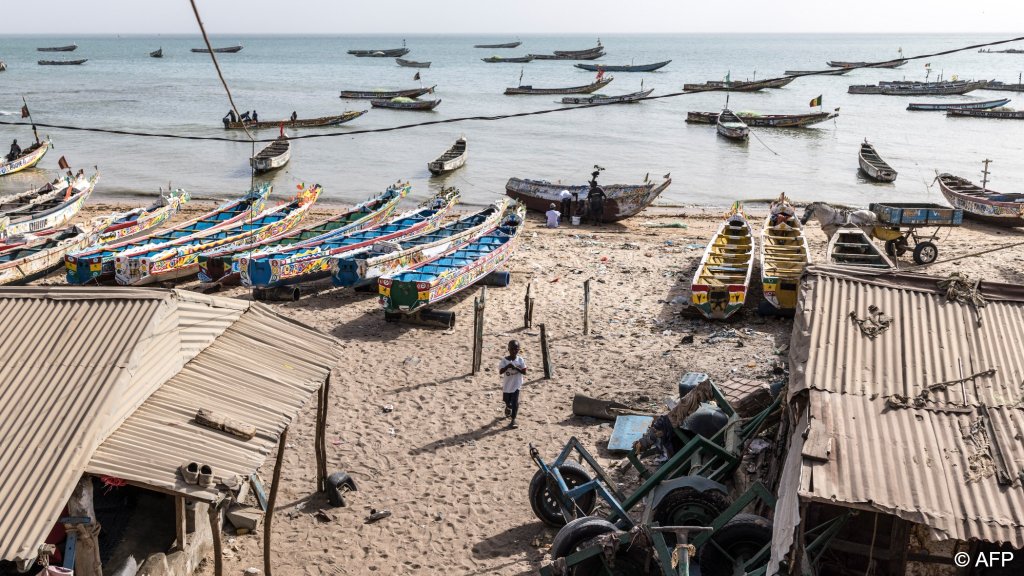 A boy walks on the beach at Mbour. Grief and the effects of the death on family members can have long-lasting consequences for those left behind in Senegal | Photo: Patrick Meinhardt / AFP