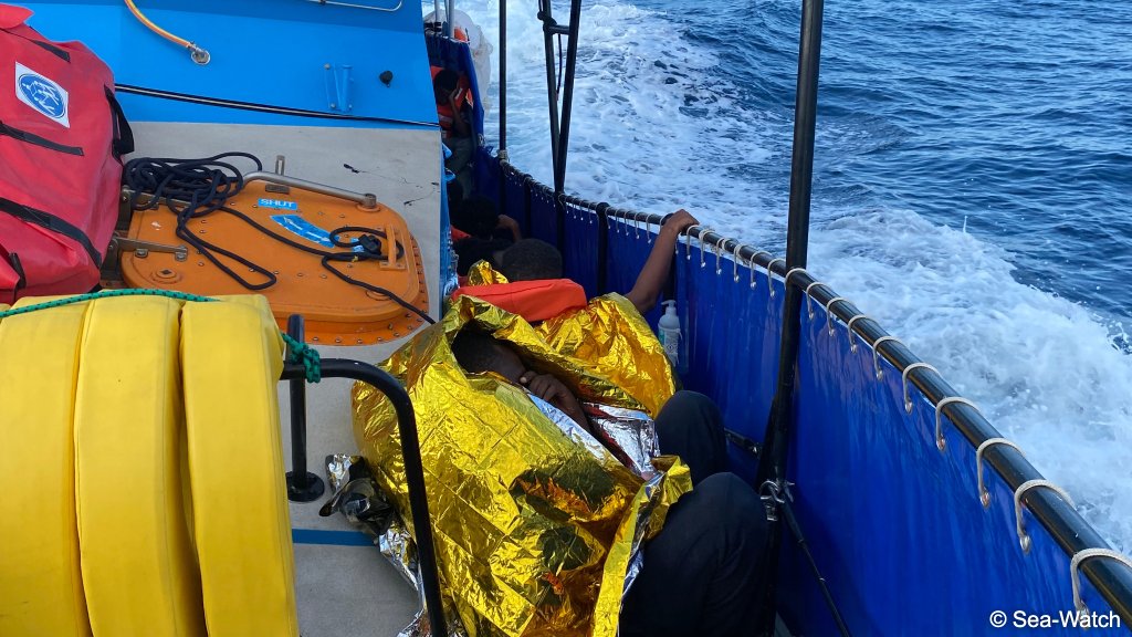 Some of the migrants are covered in recovery blankets after being picked up by the crew of the Aurora after their ship wrecked off the coast of Tunisia | Photo: Sea-Watch
