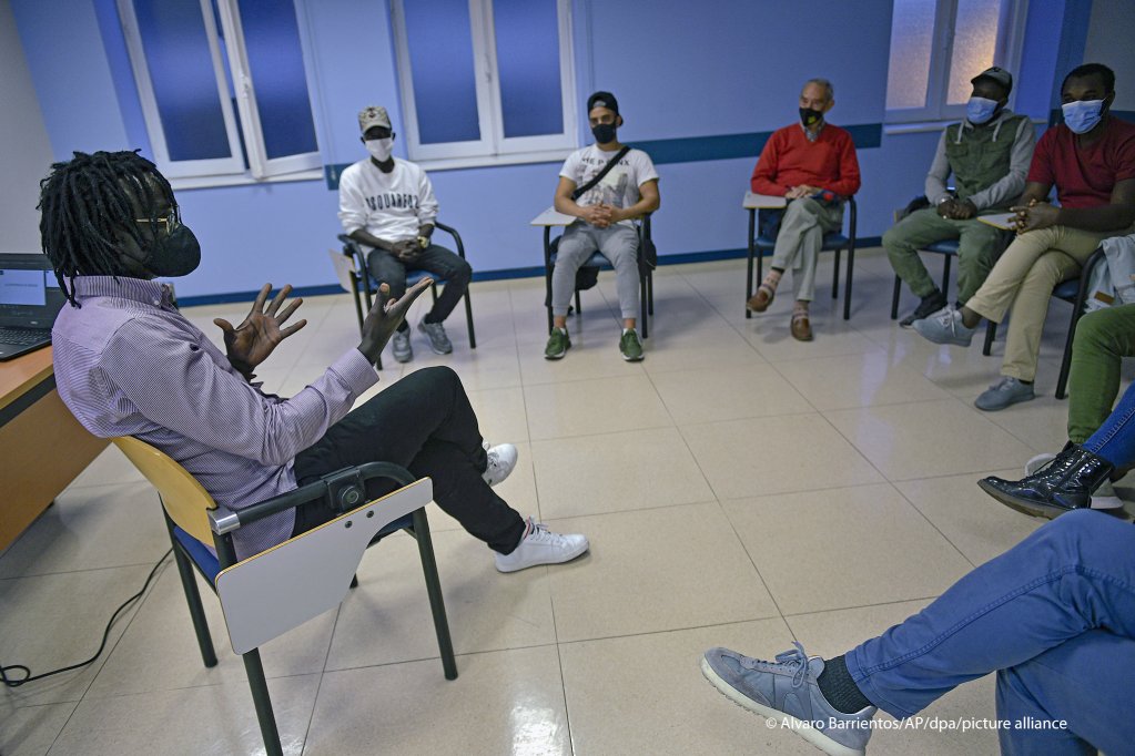 Mbaye Bbacar Diouf, left, talks with migrants and volunteers during a workshop supporting migrants in Bilbao, northern Spain | Photo: Alvaro Barrientos / AP Photo/ picture-alliance