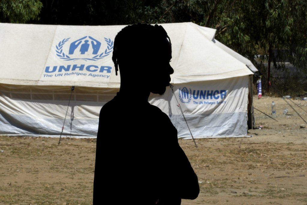 A refugee man stands in front of tent at a camp inside the UN-controlled buffer zone in the divided capital Nicosia, Cyprus on August 9, 2024 | Photo: Petros Karadjias, AP