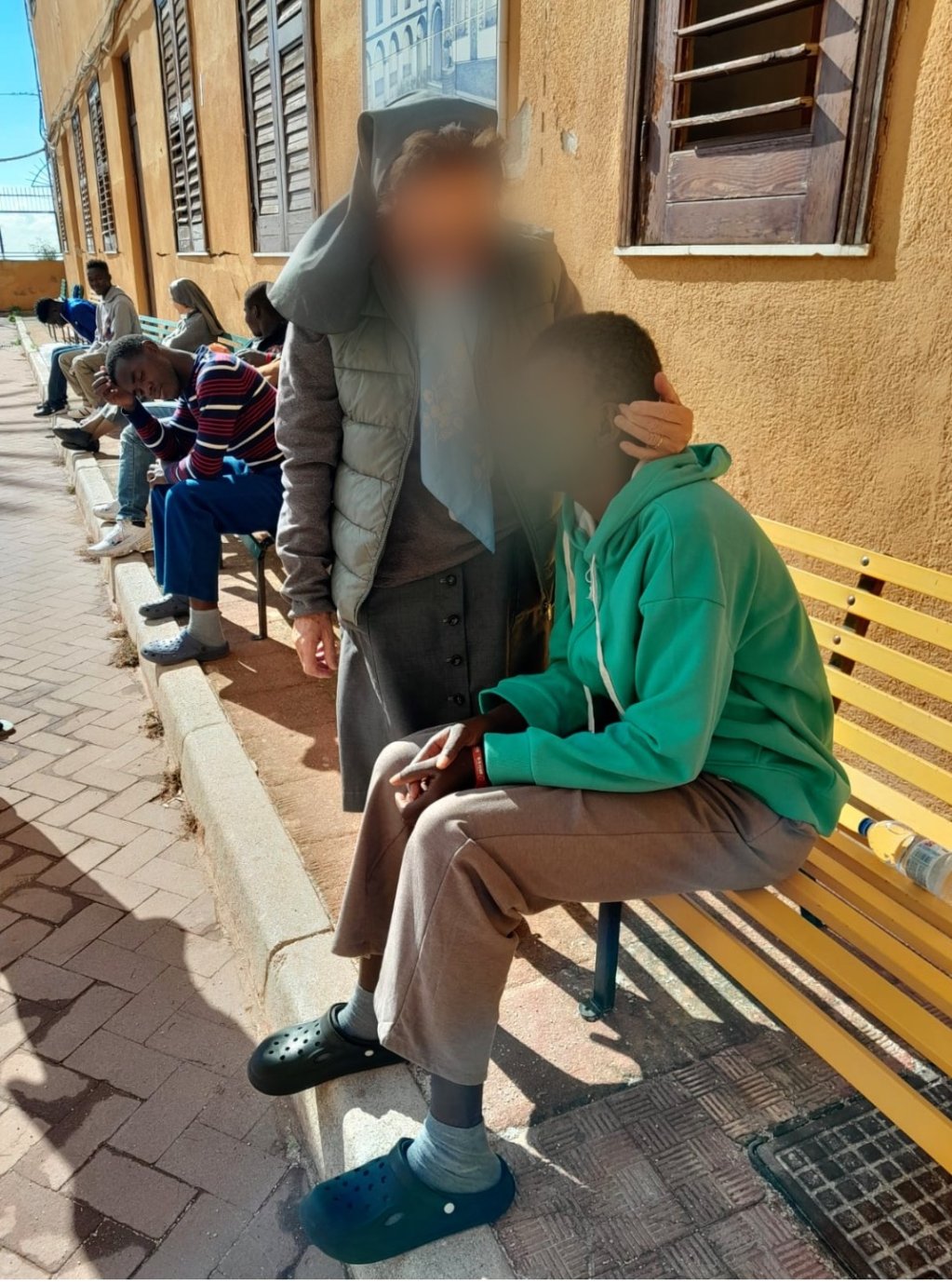 Mariame* seated in the courtyard of the shelter, November 2024 | Photo: Alessandro Puglia