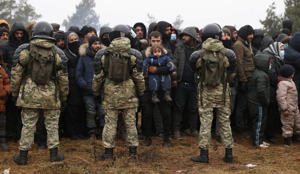 From file: Belarusian soldiers stand guard as migrants gather for the distribution of humanitarian aid in a makeshift camp on the Belarusian side of the Polish eastern border. Photo: Oksana Manchuk/BelTA/Handout via Reuters