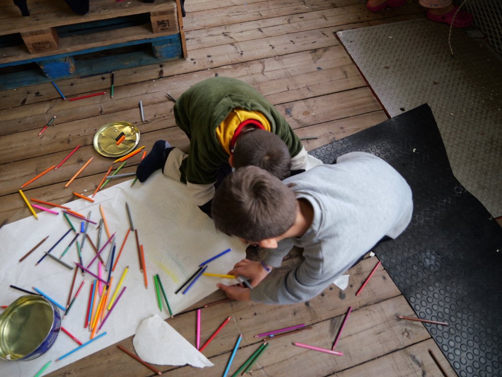 Two Syrian children draw pictures on board the Geo Barents in the Central Mediterranean Sea a few days after their rescue | February, 2024 | Photo: Sou-Jie van Brunnersum