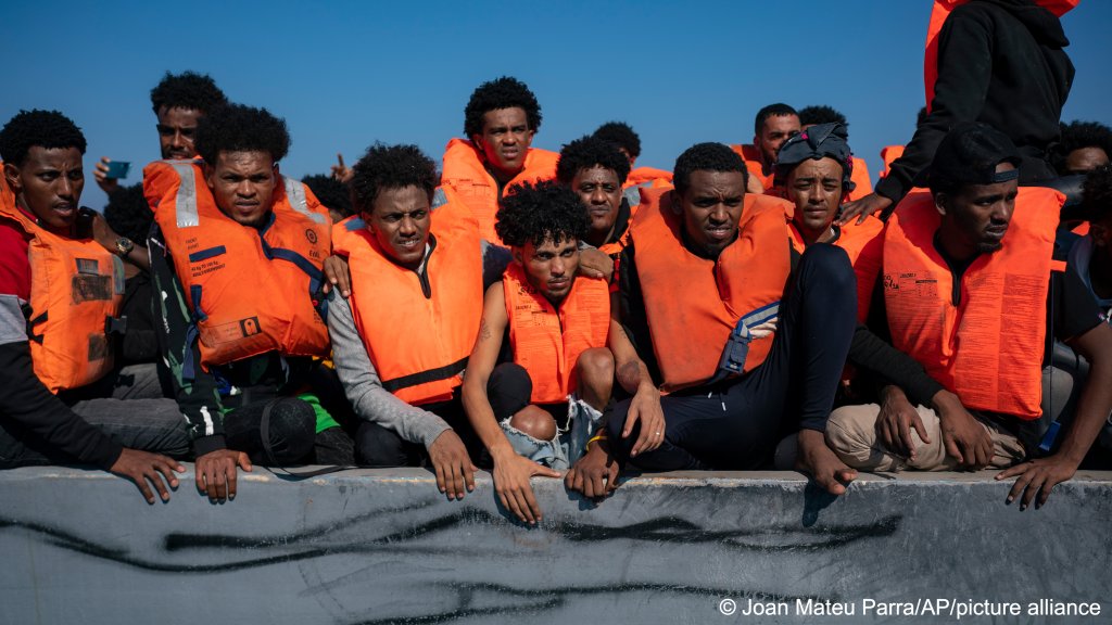 FROM FILE: Smugglers tend to pack dozens of people onto unseaworthy vessels, as seen here in June 2023 | Photo: AP Photo / Joan Mateu Parra / picture-alliance