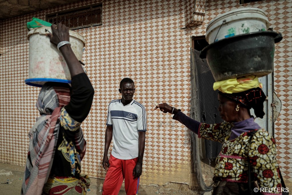 Mbaye (C), talks to his relatives during his daily morning walk, in Fass Boye, Senegal, March 20, 2024 | Photo: REUTERS/Zohra Bensemra