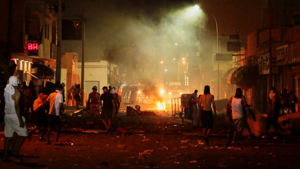 Demonstrators clash with security forces during a protest, following the sinking of a migrant boat bound for Italy, in Ben Guerdane, Tunisia, August 24, 2026. REUTERS/Ahmed Jarray