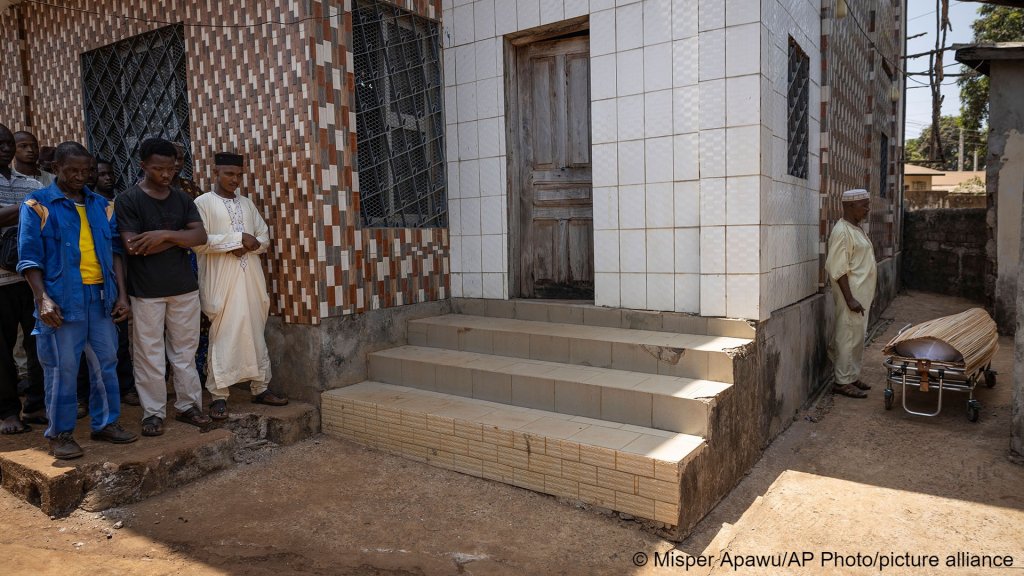 Mourners have gathered for Ousmane Sylla's funeral in Conakry on April 09, with his coffin featured in the right | Photo: AP Photo / Misper Apawu