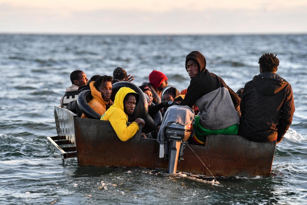 File photo used for illustration: Migrants in a boat headed for Italy, off Sfax, Tunisia | Photo: AFP - FETHI BELAID