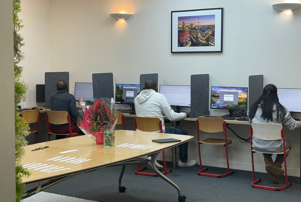 Three candidates taking the civic exam, February 14, 2026 | Photo: InfoMigrants