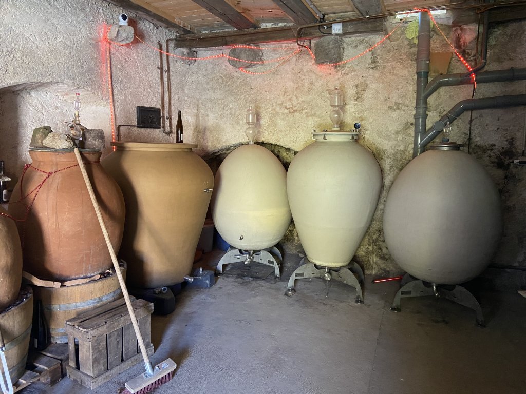 Haroon Rahimi makes his wine in different containers in his cellar: Roman jars, Georgian jars called Qvevri (left), and wooden barrels | Photo: InfoMigrants