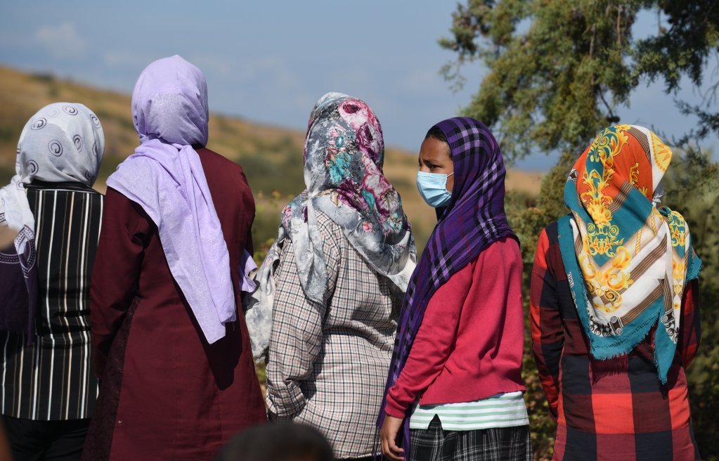 Une femme porte un masque lors d'une distribution de nourriture organisée sur la route entre Moria et Mytilène, à Lesbos. Crédit : Mehdi Chebil pour InfoMigrants.