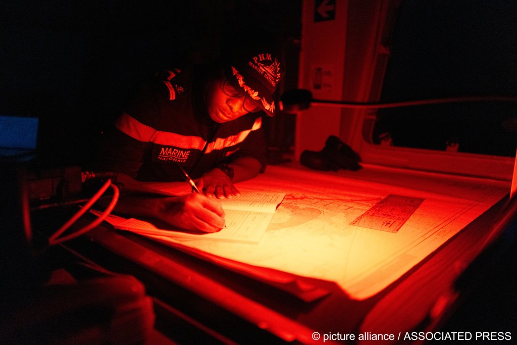 A Senegalese sailor fills in the logbook of the offshore patrol vessel Niani during a mission to search for migrant boats | Photo: Sylvain Cherkaoui / AP Photo