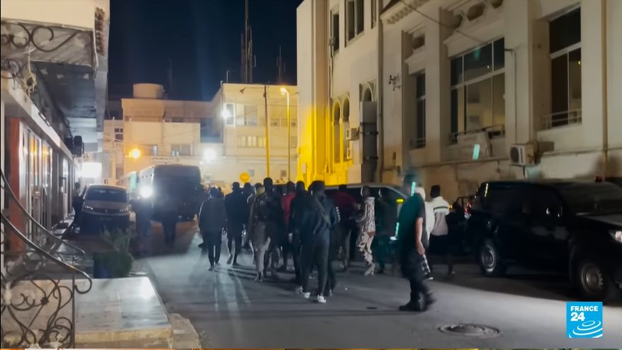 This video footage shows sub-Saharan African migrants being asked to board a bus, destination unknown | Source: Screenshot of France 24 TV news report
