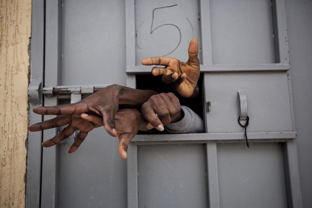 File photo used as illustration: Hands of migrants in a prison in Libya | Photo: Reuters