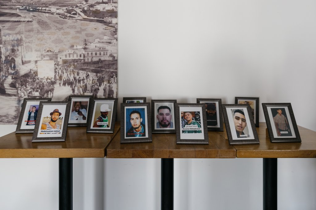 During the two-day "Justice for the Missing" forum organized by Euromed in Rabat, framed photographs were displayed on a table in tribute to those who went missing on the path to Europe | Photo: Valentina Camu (Divergence)