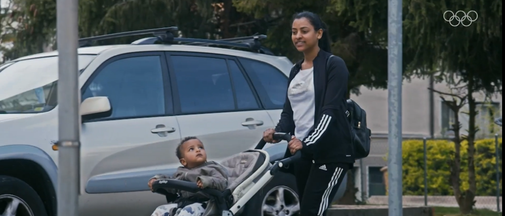 Luna and her baby ahead of the Tokyo Olympics | Source: Screenshot from IOC film https://olympics.com/en/video/luna-solomon-epic-journey-eritrean-refugee-to-olympic-shooter