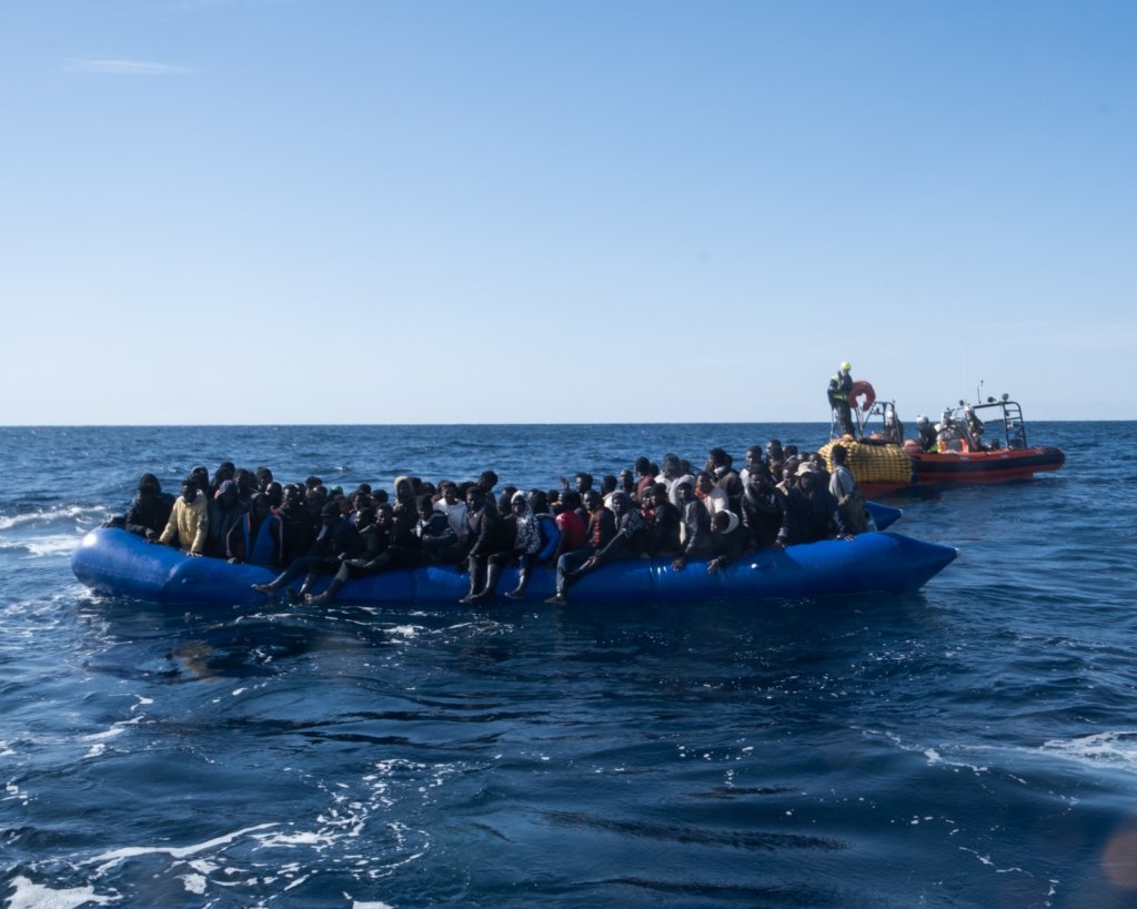 A picture of an overcrowded blue rubber boat from which the crew of the Ocean Viking rescued 95 migrants | Source: @SOSMedIntl twitter feed
