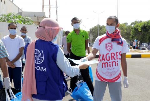 A Bangladeshi migrant is helped by the IOM in Libya as he prepares to take a voluntary flight home | Source: IOM