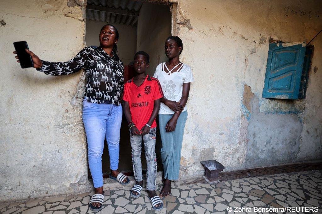 Families are left waiting at home in Senegal, hoping for the vital remittances migrants can send home. Here Mariatou, the wife of Khalifa Ndour, stands with her two children. Ndour migrated last autumn to Spain | Photo: Zohra Bensemra/Reuters