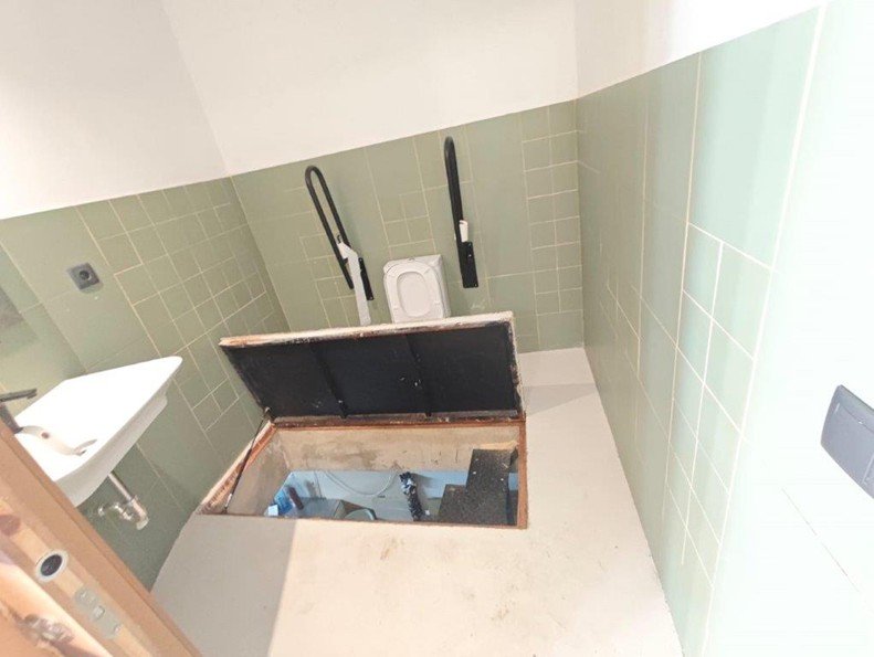 A picture of one of the bathrooms being used by migrants uncovered in an earlier operation led by Europol on November 6 | Source: Europol Press Office
