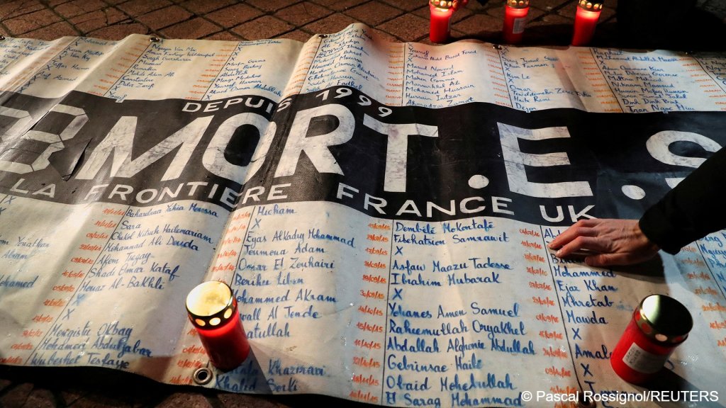 File photo: People placed candles around a banner with names of migrants who have died since 1999 while trying to cross the English Channel, during a memorial for the 27 migrants who died when their dinghy deflated in the English Channel. Photographed at the Richelieu Park in Calais, France, on November 25, 2021 | Photo: REUTERS/Pascal Rossignol